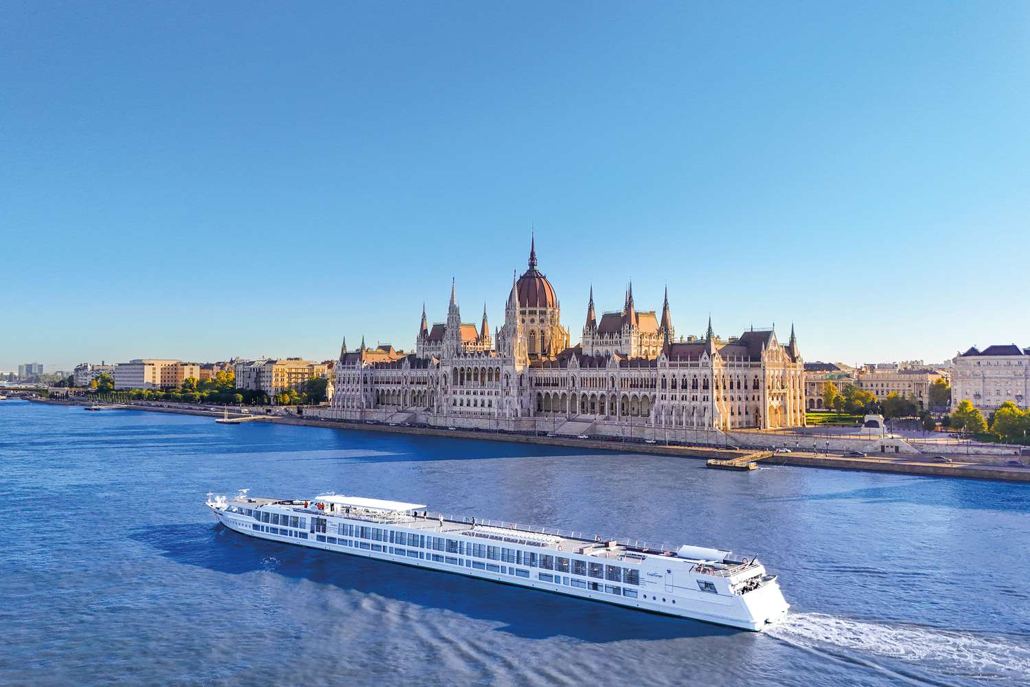 A river cruise boat on the Danube passing by a historic European capital